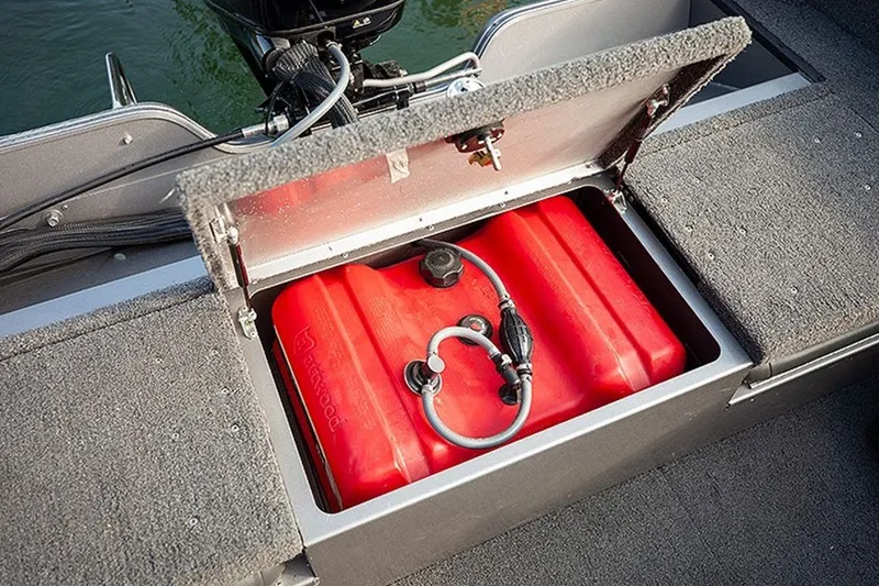 Slide: The Image of Open storage compartment in 2027 Lowe Fishing Machine 1625WT boat, revealing red fuel tank. - 3