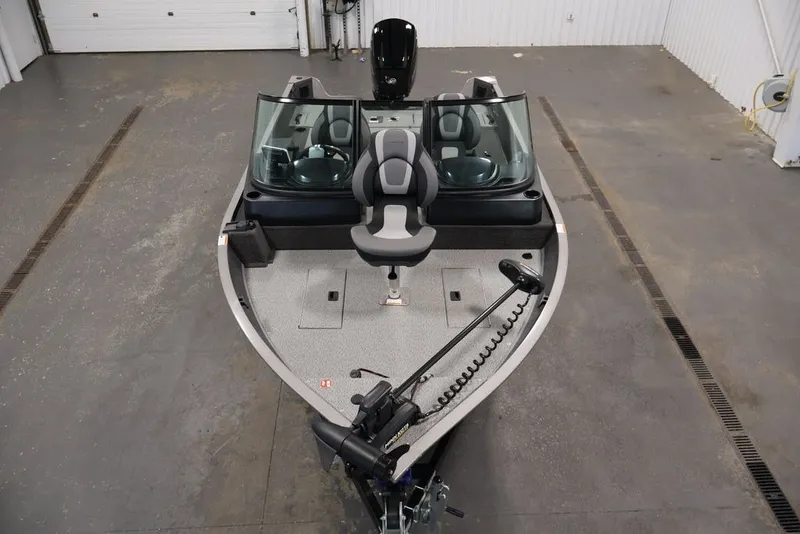 Slide: The Image of 2027 Lowe Fishing Machine 1675WT boat in a garage, featuring a sleek design. - 40