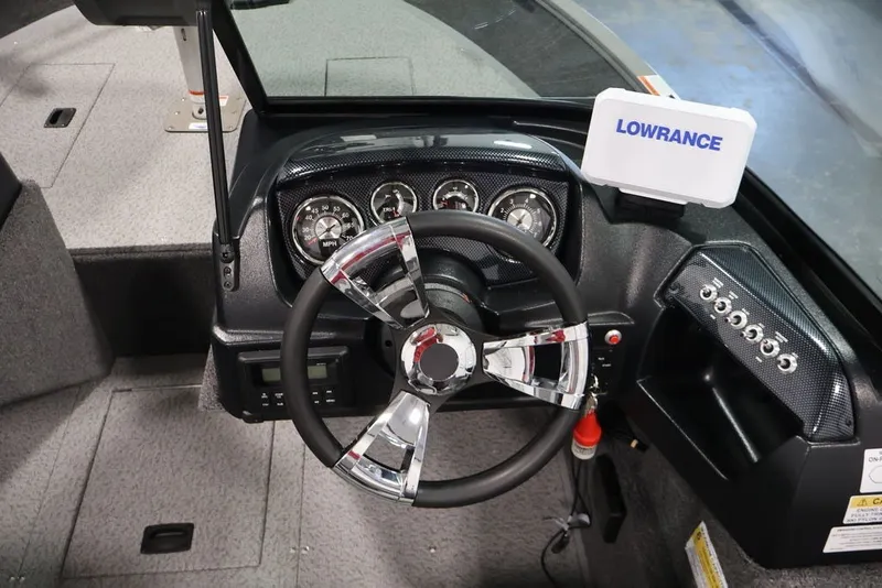 Slide: The Image of 2027 Lowe Fishing Machine 1675WT dashboard with steering wheel and Lowrance display. - 30