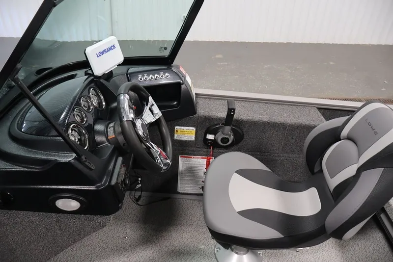 Slide: The Image of Interior of 2027 Lowe Fishing Machine 1675WT with steering wheel and comfortable seating. - 27