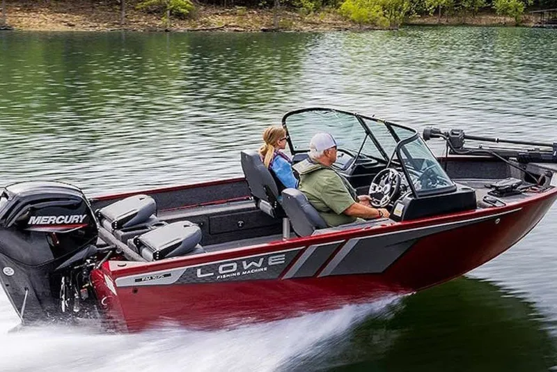 Slide: The Image of 2027 Lowe Fishing Machine 1675WT boat cruising on a lake with two passengers. - 52