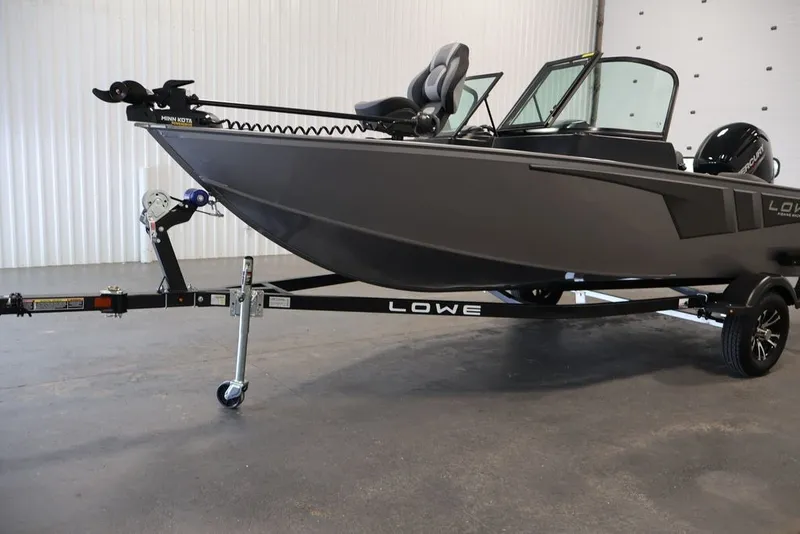 Slide: The Image of 2027 Lowe Fishing Machine 1675WT boat on trailer in indoor setting. - 46