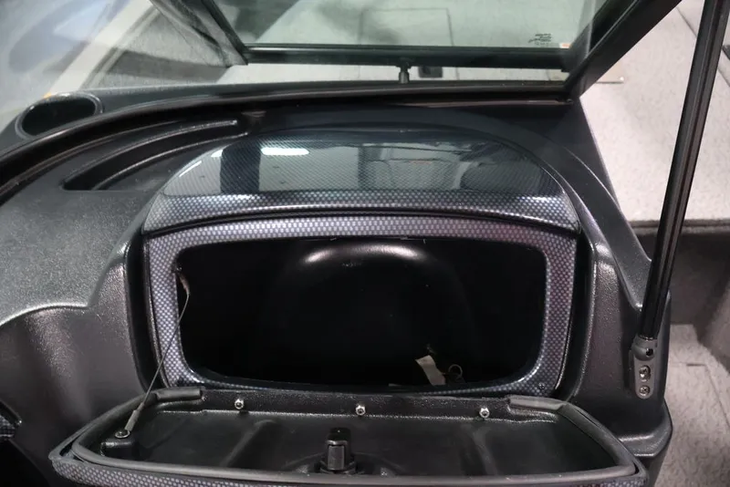 Slide: The Image of 2027 Lowe Fishing Machine 1675WT dashboard compartment open, showcasing storage space. - 42