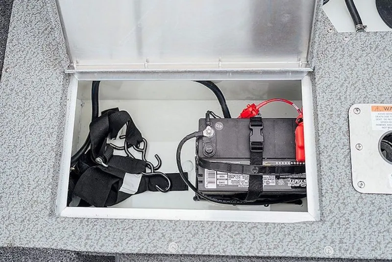 Slide: The Image of Battery compartment of 2027 Lowe Fishing Machine 1675WT boat, featuring secure battery storage. - 56