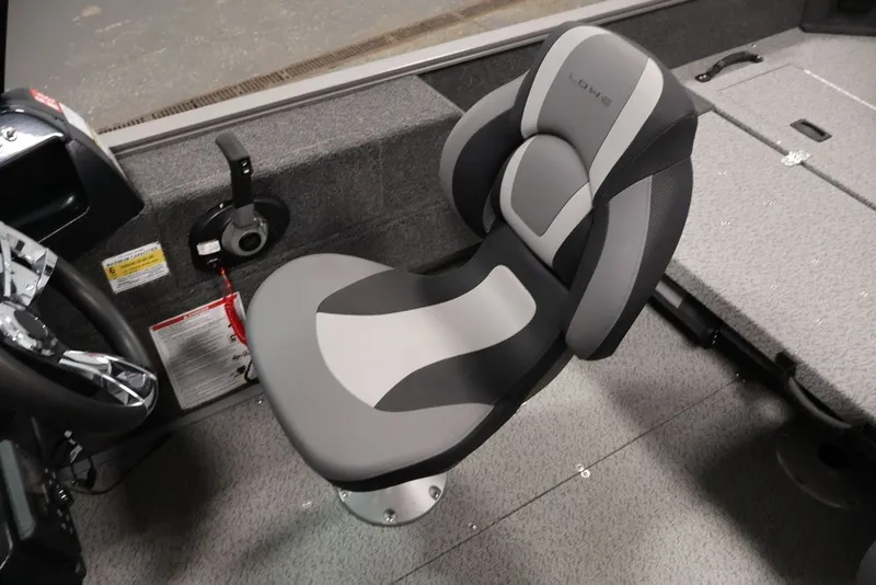 Slide: The Image of 2027 Lowe Fishing Machine 1675WT boat seat, gray and black design, steering wheel visible. - 34