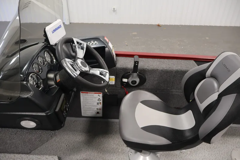 Slide: The Image of 2027 Lowe Fishing Machine 1775SC interior with steering wheel and comfortable seating. - 19