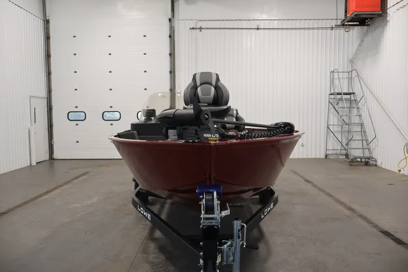 Slide: The Image of 2027 Lowe Fishing Machine 1775SC boat in a garage, front view. - 1