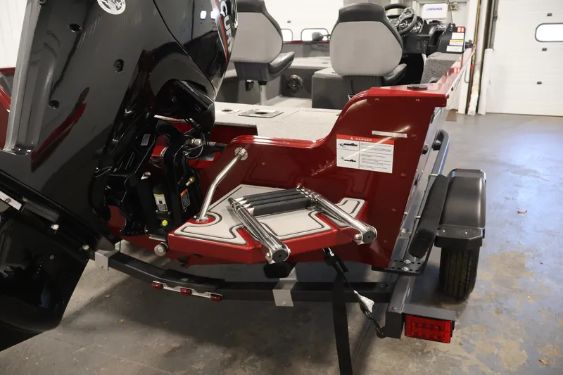 Slide: The Image of 2027 Lowe Fishing Machine 1775SC boat with motor and trailer in a garage. - 34
