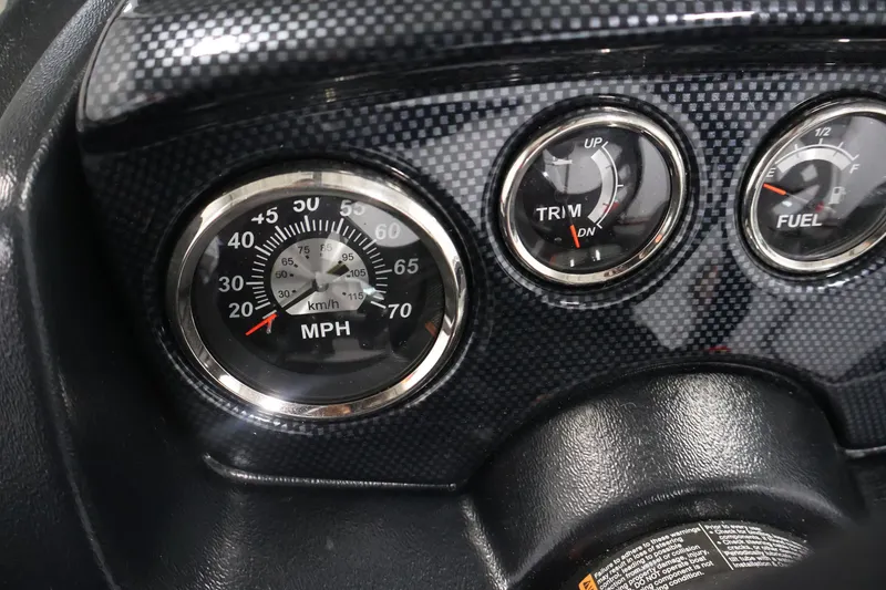 Slide: The Image of Dashboard gauges of 2027 Lowe Fishing Machine 1775SC, showing speed, trim, and fuel levels. - 22