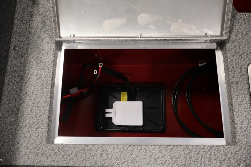 Slide: The Image of Battery compartment of 2027 Lowe Fishing Machine 1775SC boat, featuring wiring and storage. - 33