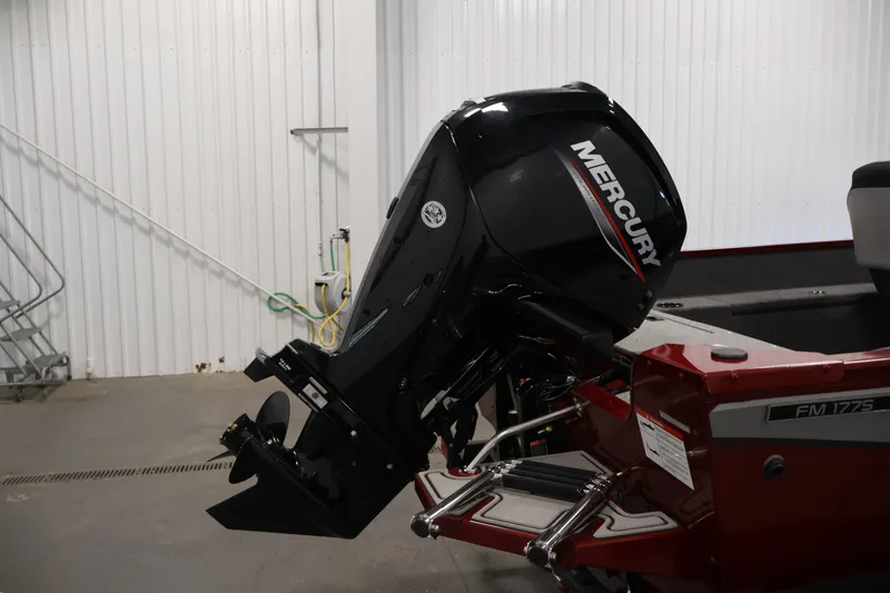 Slide: The Image of 2027 Lowe Fishing Machine 1775SC with Mercury outboard motor in a garage setting. - 35