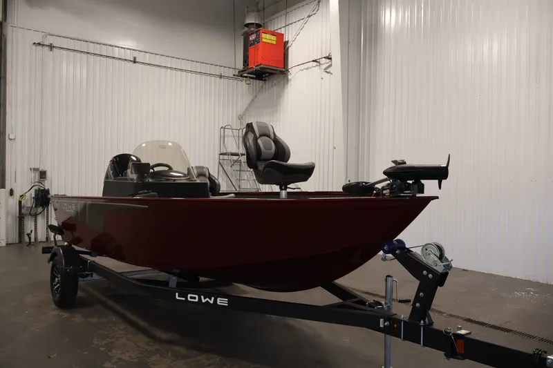 Slide: The Image of 2027 Lowe Fishing Machine 1775SC boat in indoor storage on trailer. - 2