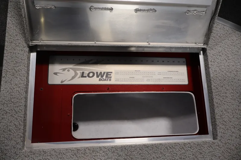 Slide: The Image of Open storage compartment in a 2027 Lowe Fishing Machine 1775SC boat. - 14