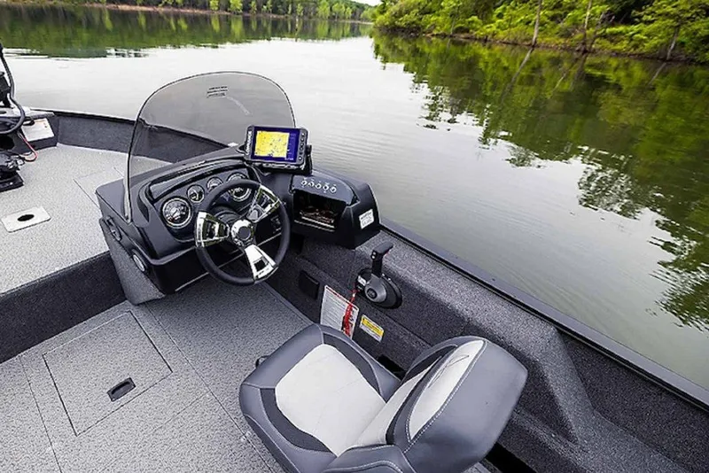 Slide: The Image of 2027 Lowe Fishing Machine 1775SC boat interior with steering wheel and navigation system. - 2