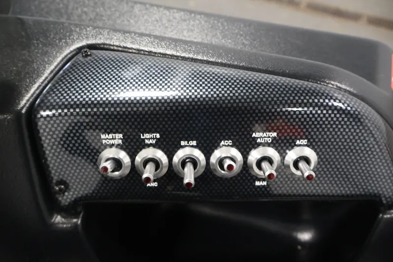 Slide: The Image of Control panel of 2027 Lowe Fishing Machine 1775SC with toggle switches. - 26
