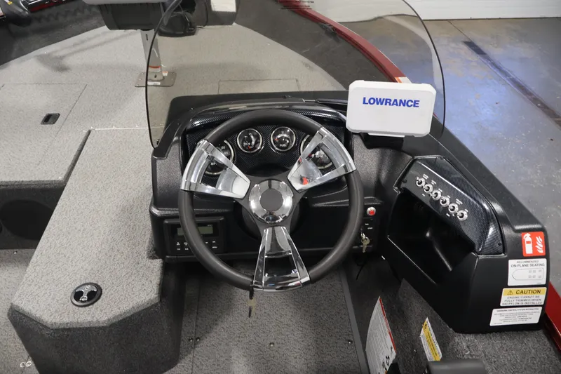 Slide: The Image of 2027 Lowe Fishing Machine 1775SC dashboard with steering wheel and Lowrance display. - 20