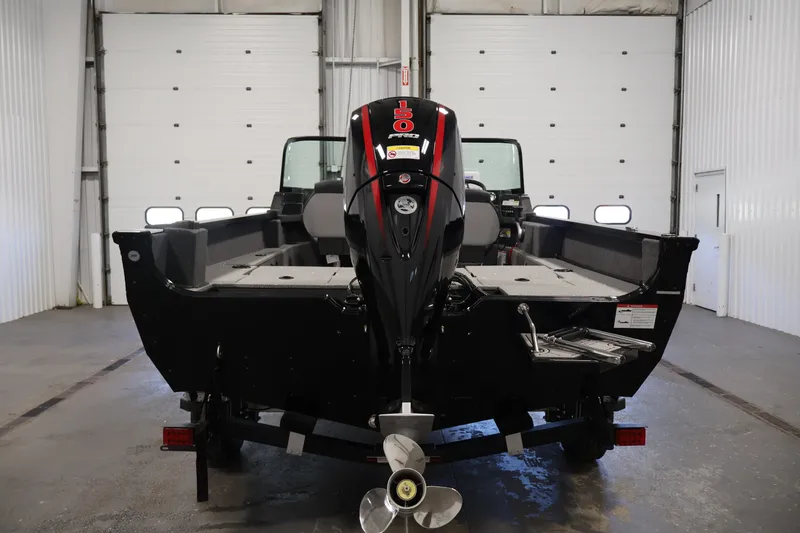 Slide: The Image of 2027 Lowe Fishing Machine 1875 boat with powerful outboard motor in a garage setting. - 5