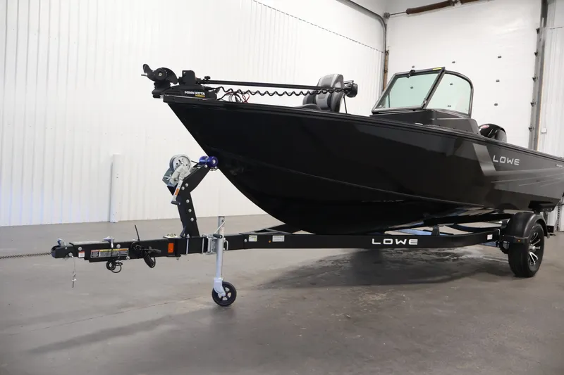 Slide: The Image of 2027 Lowe Fishing Machine 1875 boat on trailer in indoor setting. - 42