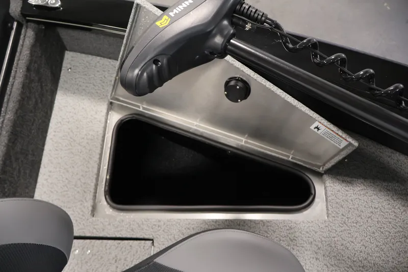 Slide: The Image of 2027 Lowe Fishing Machine 1875 boat interior with storage compartment and trolling motor. - 13