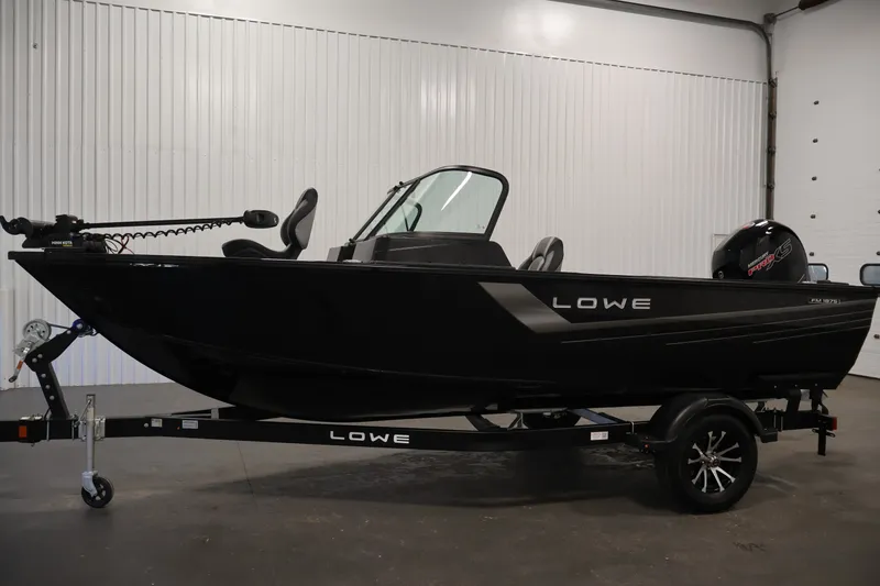 Slide: The Image of 2027 Lowe Fishing Machine 1875 boat on trailer in indoor setting. - 7