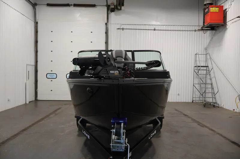 Slide: The Image of 2027 Lowe Fishing Machine 1875 boat in a garage, front view with Minn Kota trolling motor. - 1