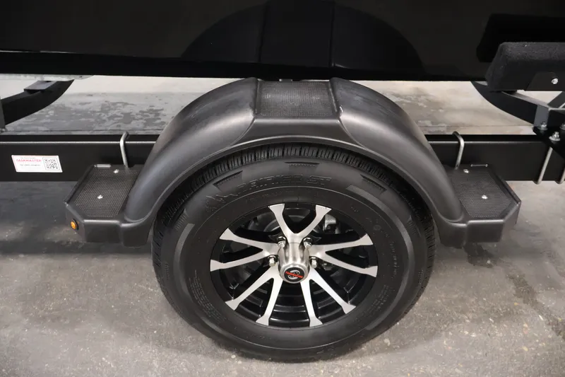 Slide: The Image of 2027 Lowe Fishing Machine 1875 trailer wheel with black fender and step detail. - 43