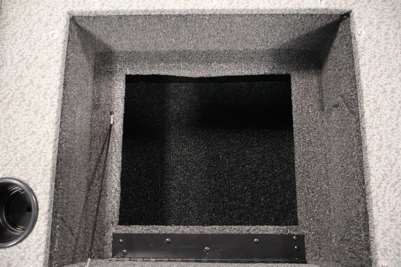 Slide: The Image of 2027 Lowe Fishing Machine 1875 storage compartment, carpeted interior, open hatch view. - 32
