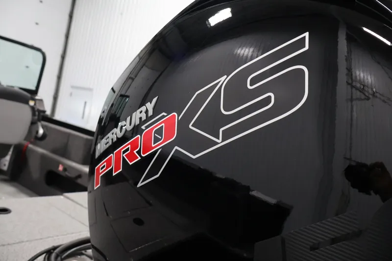 Slide: The Image of 2027 Lowe Fishing Machine 1875 with Mercury Pro XS engine in a garage setting. - 38