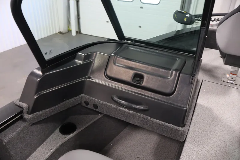 Slide: The Image of 2027 Lowe Fishing Machine 1875 interior with storage compartment and seating area. - 28