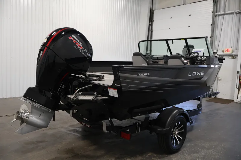Slide: The Image of 2027 Lowe Fishing Machine 1875 boat with Mercury Pro XS engine in a garage setting. - 4