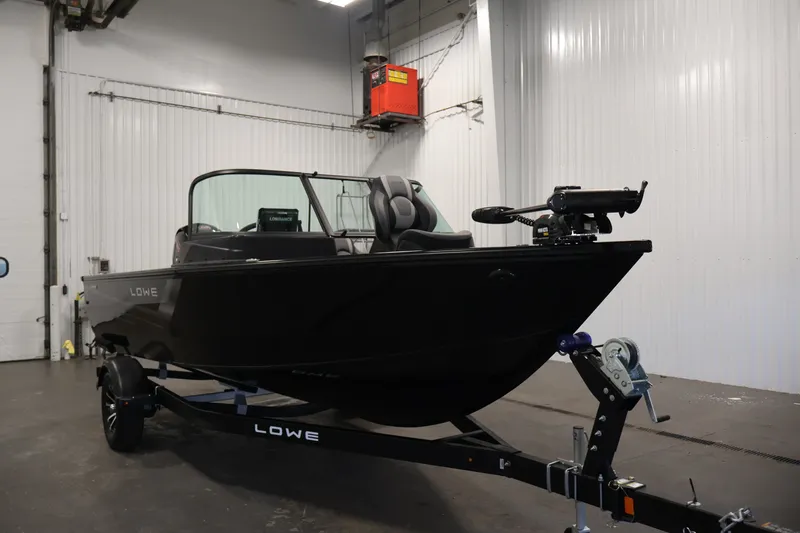 Slide: The Image of 2027 Lowe Fishing Machine 1875 boat on trailer in indoor setting. - 2