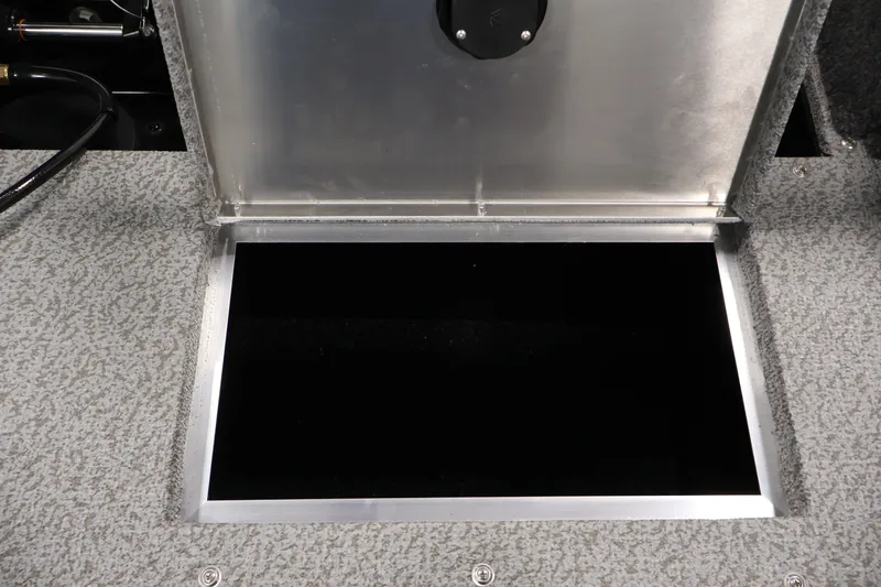 Slide: The Image of Open storage compartment on 2027 Lowe Fishing Machine 1875 boat deck. - 35