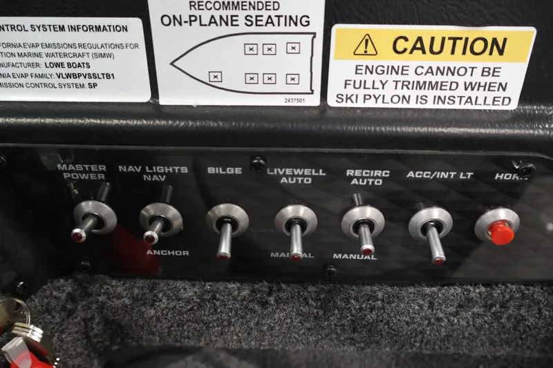 Slide: The Image of Control panel of 2027 Lowe Fishing Machine 1875 with various switches and caution labels. - 24