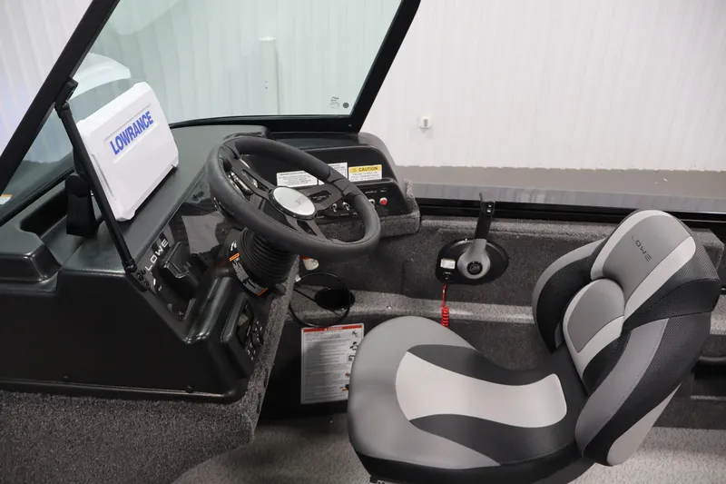 Slide: The Image of 2027 Lowe Fishing Machine 1875 cockpit with steering wheel and comfortable seating. - 16