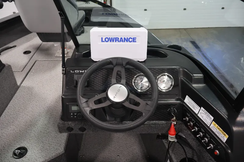 Slide: The Image of 2027 Lowe Fishing Machine 1875 dashboard with Lowrance electronics and steering wheel. - 17