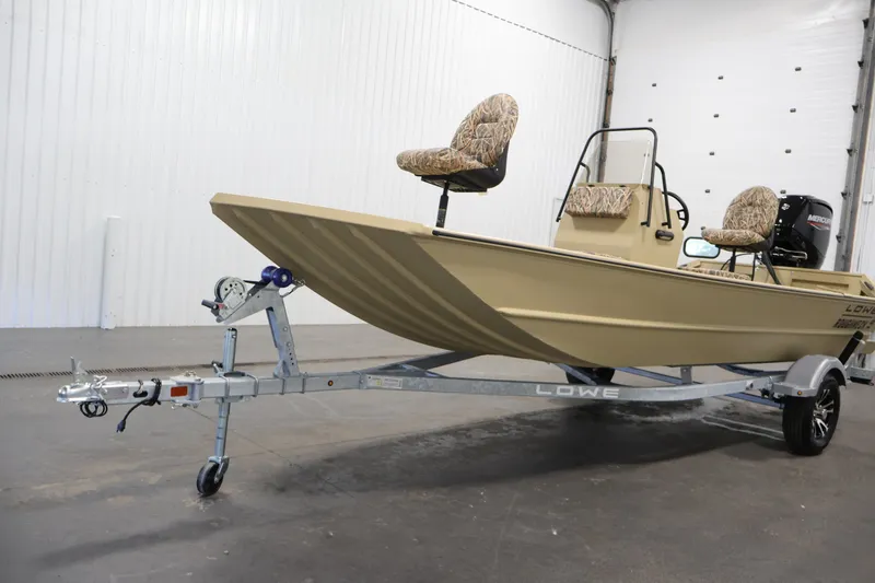 Slide: The Image of 2027 Lowe Roughneck RX1860 Tunnel Jet boat on trailer in indoor setting. - 31