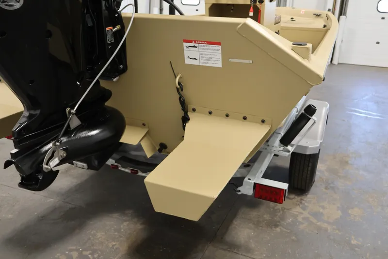 Slide: The Image of 2027 Lowe Roughneck RX1860 Tunnel Jet boat rear view in a garage setting. - 26