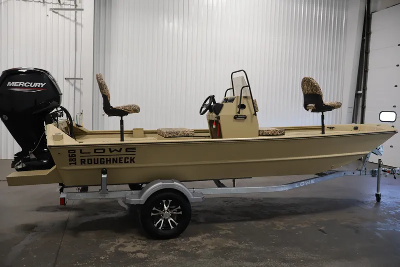 Slide: The Image of 2027 Lowe Roughneck RX1860 Tunnel Jet boat with Mercury engine on trailer in garage. - 3