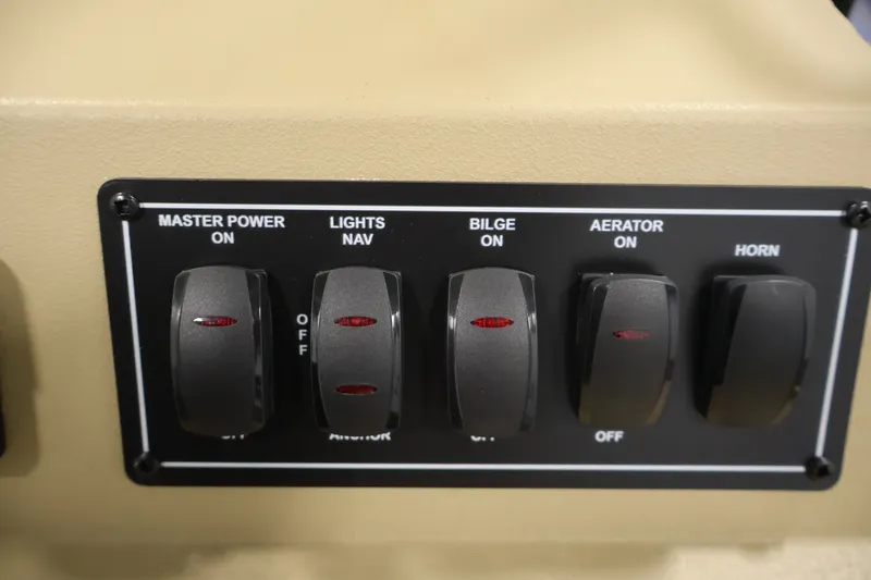 Slide: The Image of Control panel of 2027 Lowe Roughneck RX1860 Tunnel Jet boat with switches for power, lights, bilge, aerator, and horn. - 20