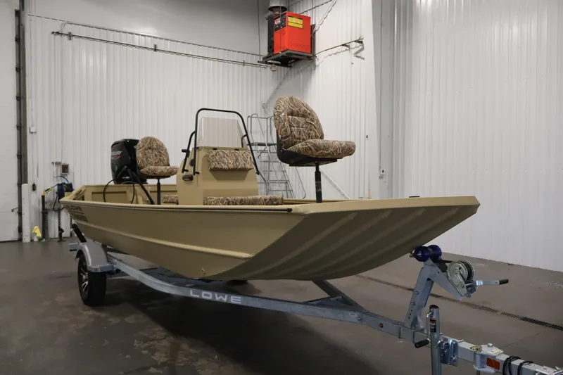 Slide: The Image of 2027 Lowe Roughneck RX1860 Tunnel Jet boat on trailer in indoor setting. - 2