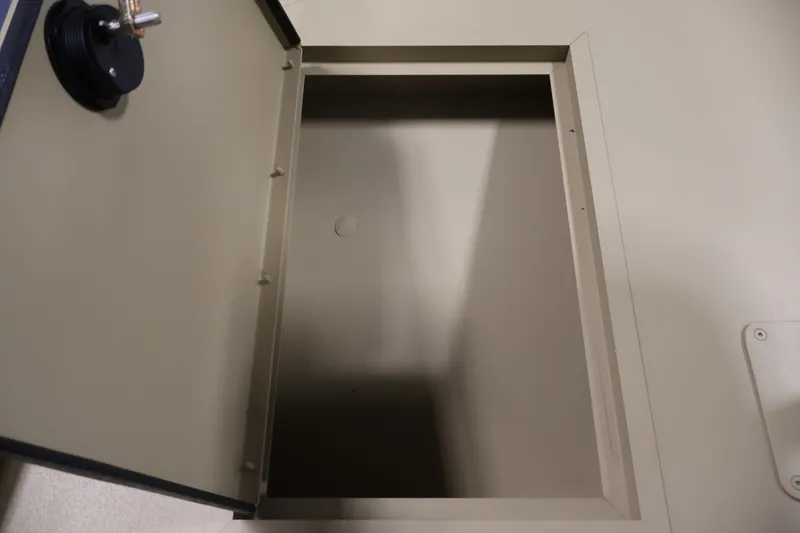 Slide: The Image of Open storage compartment on a 2027 Lowe Roughneck RX1860 Tunnel Jet boat. - 11