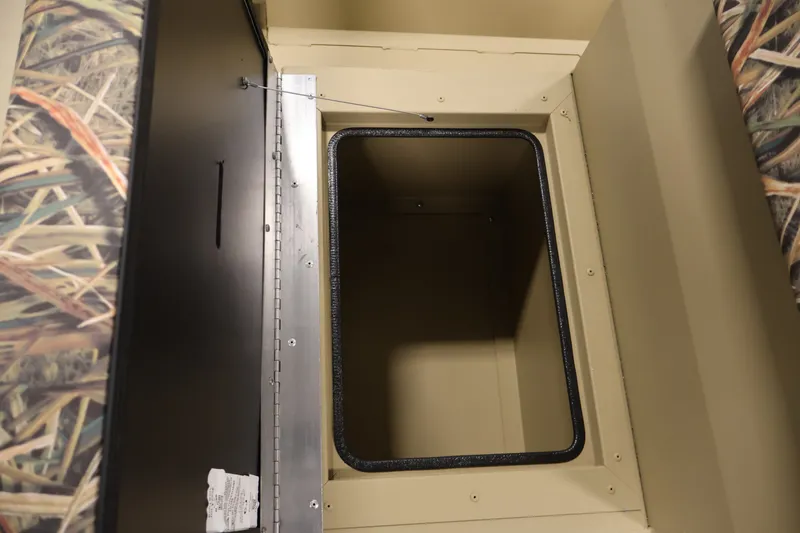 Slide: The Image of Storage compartment of 2027 Lowe Roughneck RX1860 Tunnel Jet boat, featuring camo design. - 15