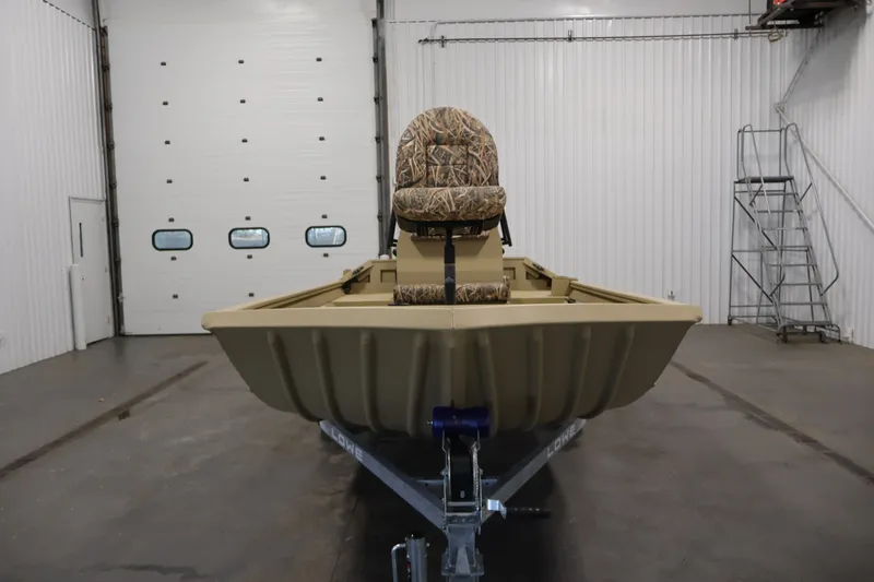 Slide: The Image of 2027 Lowe Roughneck RX1860 Tunnel Jet boat in a garage, featuring camouflage seating. - 1