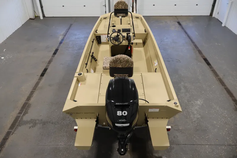 Slide: The Image of 2027 Lowe Roughneck RX1860 Tunnel Jet boat with Mercury 80 engine in a garage. - 9