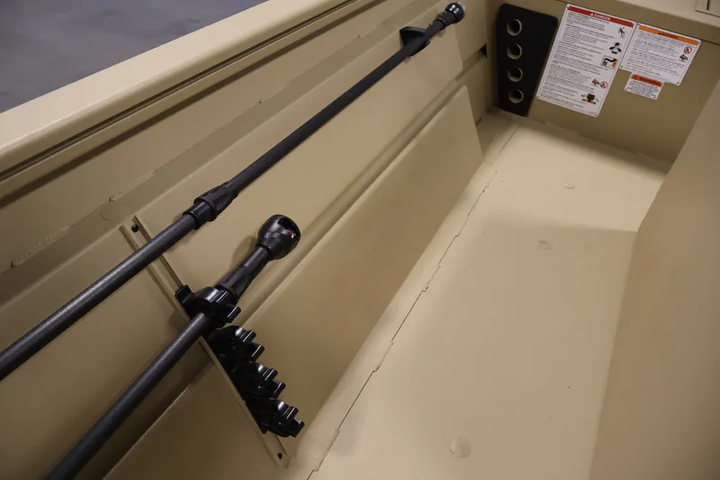 Slide: The Image of Interior view of 2027 Lowe Roughneck RX1860 Tunnel Jet boat, featuring rod holders and safety instructions. - 16