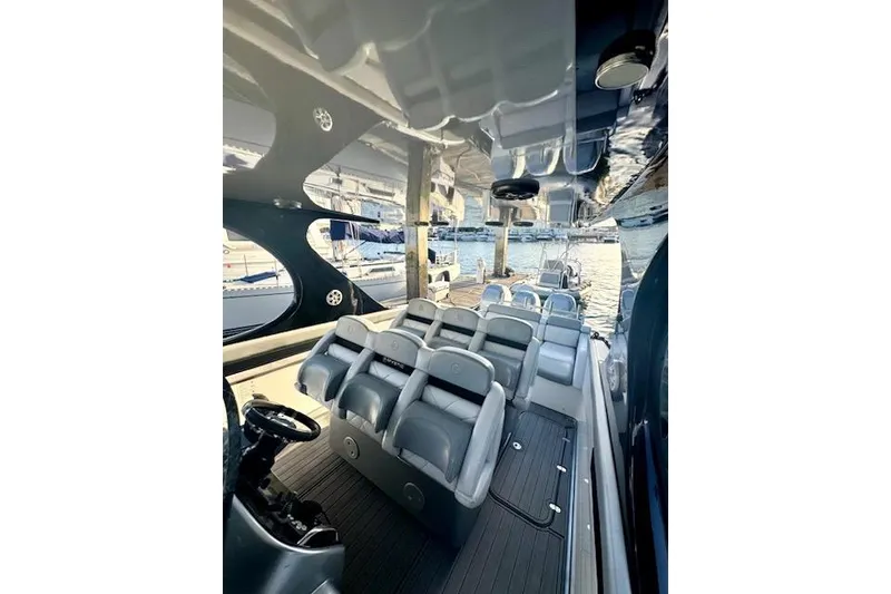 Slide: The Image of Interior view of a 2016 Mystic M4200 boat with sleek seating and modern design. - 10