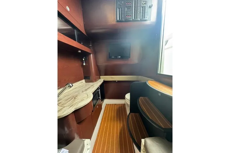 Slide: The Image of Interior of 2016 Mystic M4200 boat with wood accents and modern amenities. - 5