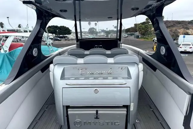 Slide: The Image of Luxury Mystic M4200 boat interior with sleek seating, docked at a marina, 2016 model. - 7