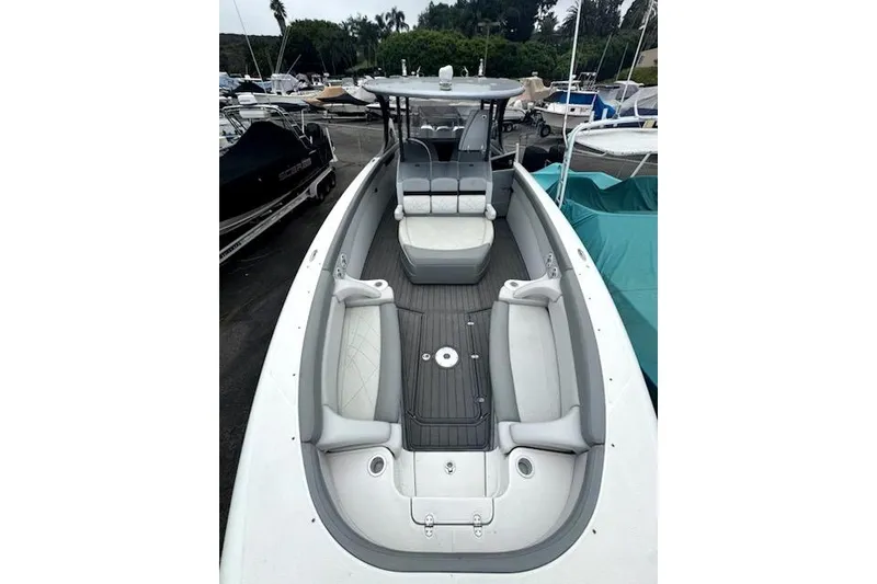 Slide: The Image of 2016 Mystic M4200 boat with spacious seating and sleek design in a marina setting. - 8