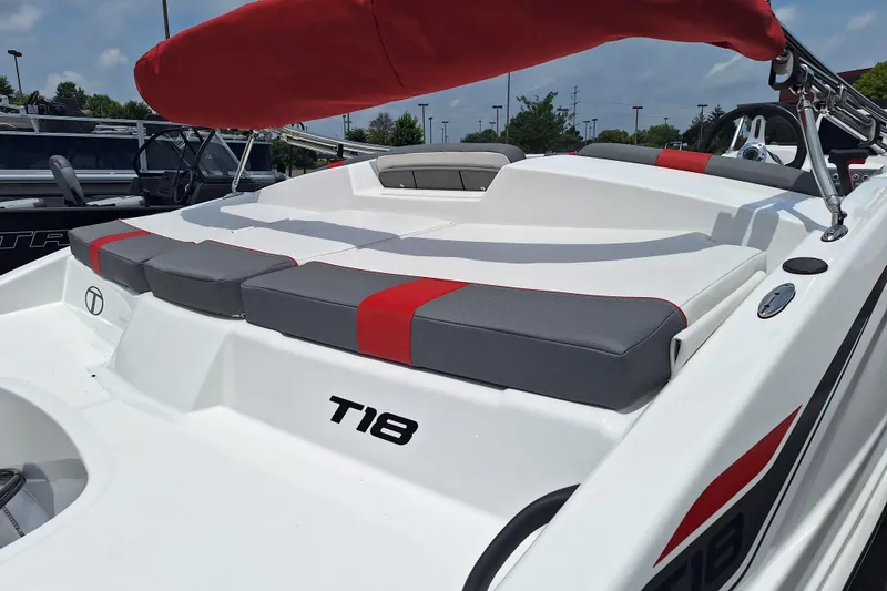 Slide: The Image of 2026 Tahoe T18 boat with red and gray seating, sleek design, and modern features. - 6